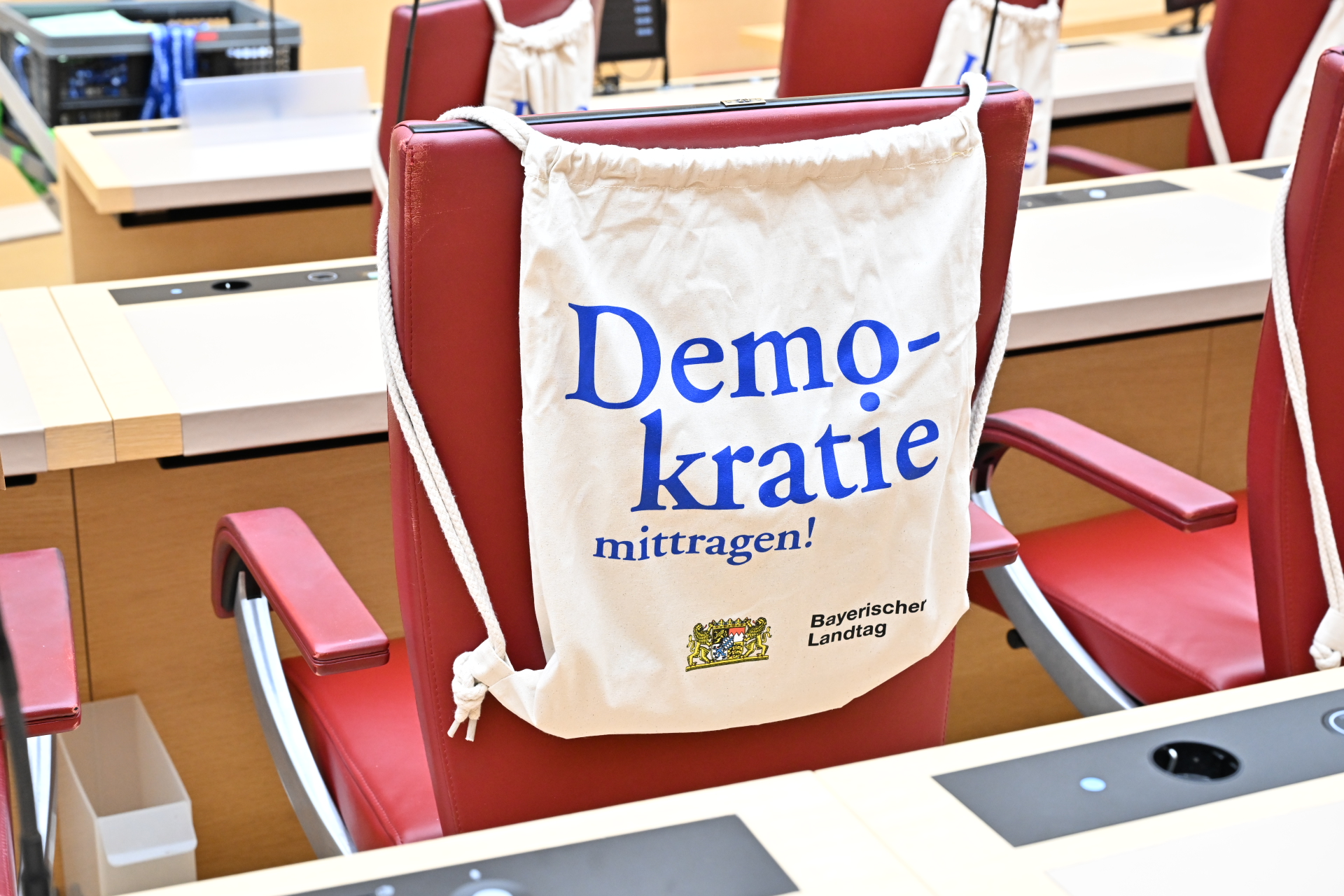Eine Jutebeutel hängt an einem der Sitze im Plenarsaal des Bayerischen Landtags bei dem Projekt „(D)eine Minute für die Demokratie".